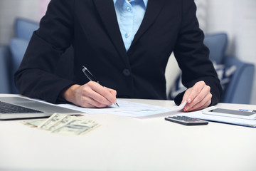 Woman counting money and making calculations
