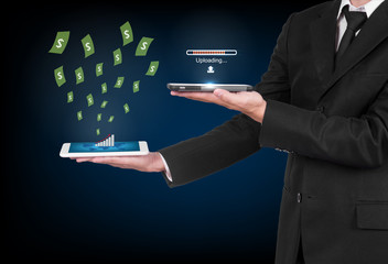 Businessman with modern mobile phone uploading data and  money f