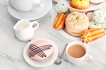Cake stand with different sweets and tea