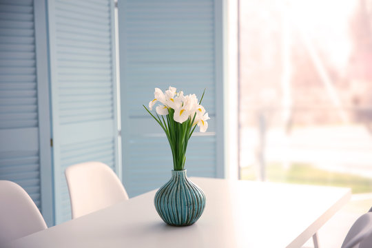 Fresh white irises on dinning table, indoors