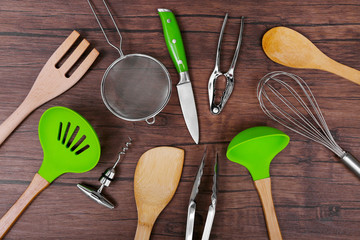 Set of stainless and wooden utensils on wooden background