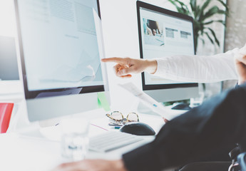 Coworking process,managers team work,new project.Photo young business crew working with startup modern office.Desktop computer on table,reflection screen monitor. Blurred,film effect. Horizontal