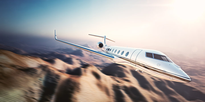 Image of white modern and luxury generic design private jet flying in blue sky at sunrise.Uninhabited desert mountains background.Business travel picture.Horizontal,motion blurred effect.3d rendering