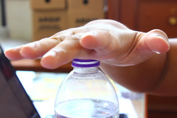 Hands opening a bottle of fresh water