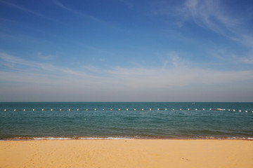 Fototapeta na wymiar Sea wave on the beach with the blue sky