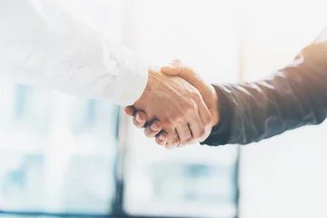 Business partnership meeting. Picture businessmans handshake. Successful businessmen handshaking after good deal. Horizontal, blurred background © SFIO CRACHO