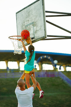 Father And Daughter Playing Basketball