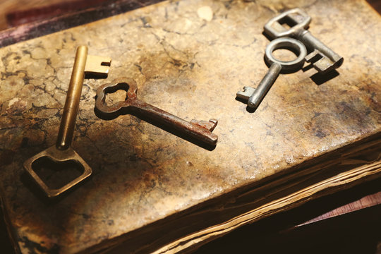 Four keys on background of old books