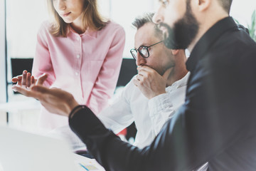 Coworkers photo in sunny office.Startupers team work new startup project.Young business crew working modern studio. Brainstorming idea. Blurred,film effect. Horizontal