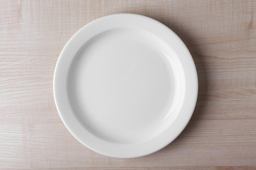 Empty plate on wooden background