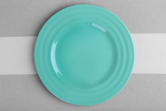 Empty plate on striped background