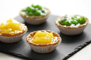 Fresh homemade fruit tarts with citruses and kiwi