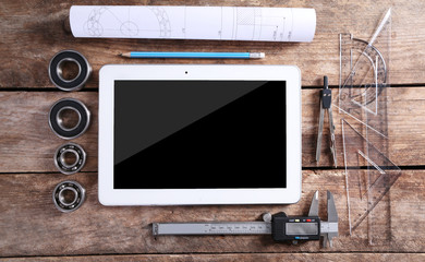 Engineering drawing with tools and tablet, top view