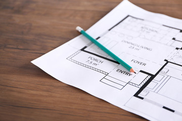 Construction drawings with pencil on wooden table closeup