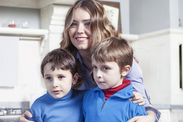 portrait of family relaxing on floor in the kitchen