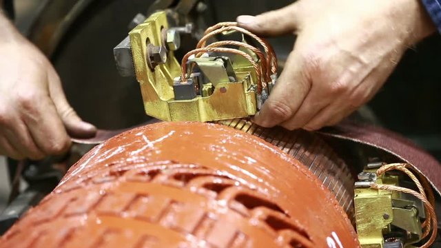 Mechanic repairing electric generator, repair of starter. motor mechanic repairs