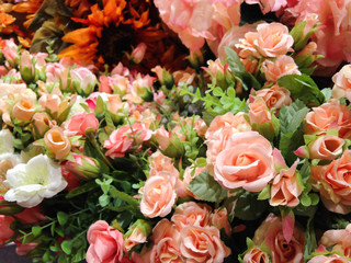 The selective focus photo of artificial orange roses