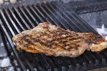 steaks cooked on a grill in the restaurant