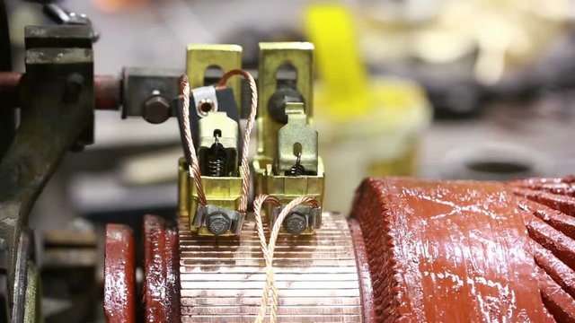 Mechanic repairing electric generator, repair of starter. motor mechanic repairs