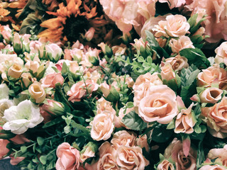 The selective focus photo of artificial orange roses