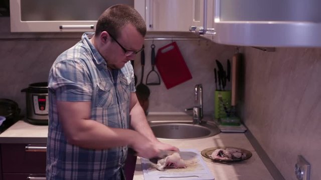 Man cuts fish steaks