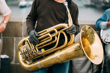Man is playing on a big tube outdoors.