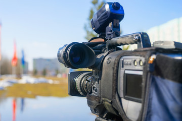 Journalistic television camera on  city street.