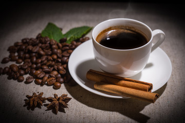 Single cup of coffee with cinnamon and spices