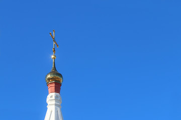 Fototapeta na wymiar Golden small dome with cross 