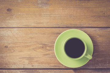 Coffee cup on yellow wooden table