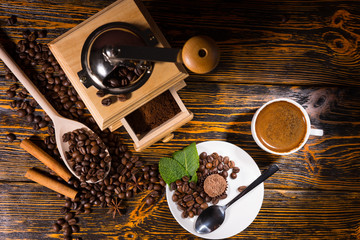 Fototapeta na wymiar Overhead view of coffee beans by grinder and mug