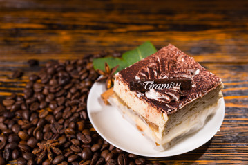 Cake slice in plate surrounded by coffee beans