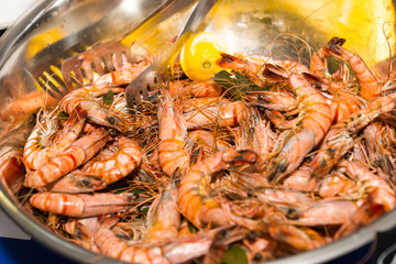 Metal Bowl Filled with Cooked Prawns and Lemon