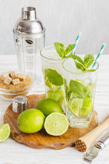 Two fresh mojitos cocktail. Mojitos with mint leaves, lime and ice