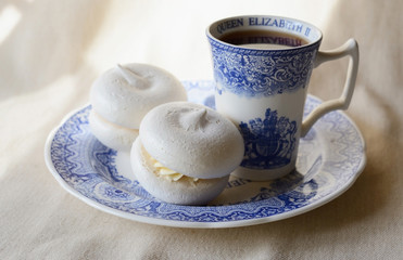 Meringue with cup of tea
