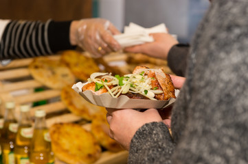 Customer purchasing tray of food from vendor