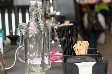 Detail empty bottles, napkins and straws