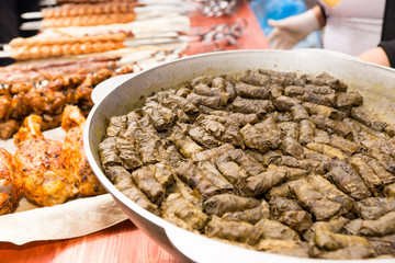 Greek Grape Leaf Rolls on Table with Grilled Meats