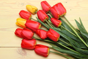 red tulips on wooden background