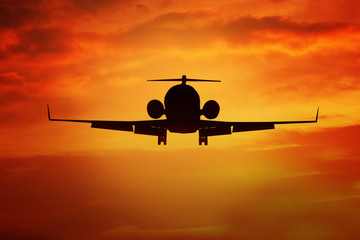 Aircraft flying on the orange sky