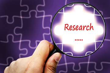 research word. Magnifier and puzzles.