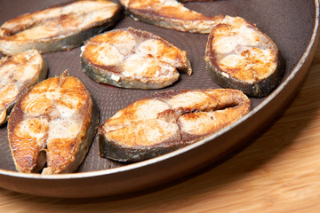 Fried fish snacks on frying pan