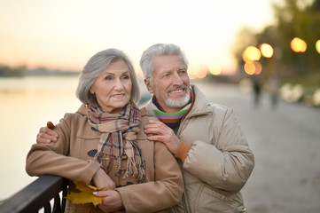 Happy senior couple  near river