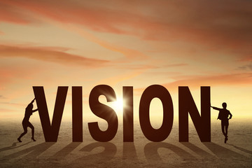 Two businesswomen and a vision word