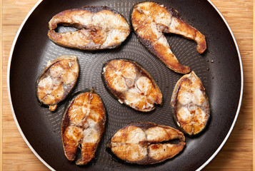 Fried fish snacks on frying pan