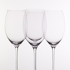 Four wine glasses on a glass desk
