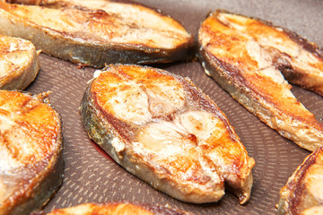 Fried fish snacks on frying pan