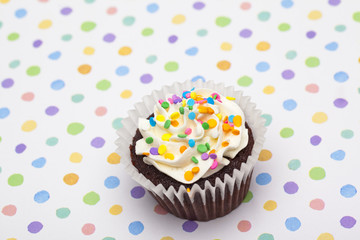 close-up image of a cupcake with sprinkles.