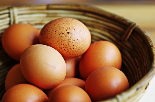 Eggs. Fresh organic raw eggs in wooden basket. Fresh eggs. Egg background. 