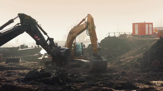 Excavators Digging Up Construction Site